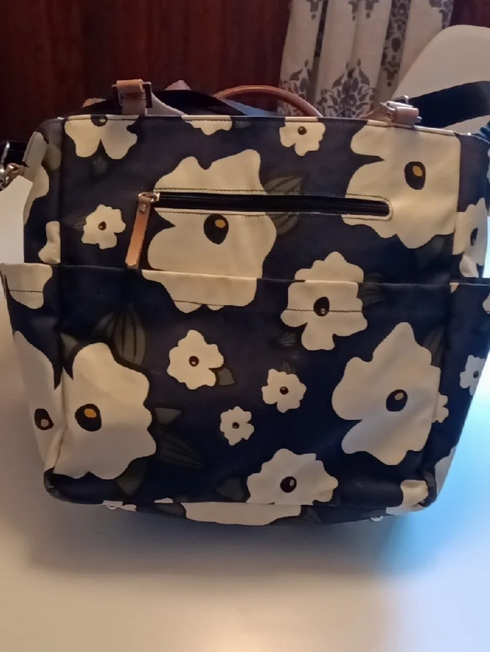Petunia Pickle Bottom Navy Floral Diaper Bag with Cream Flowers and Tan Handles